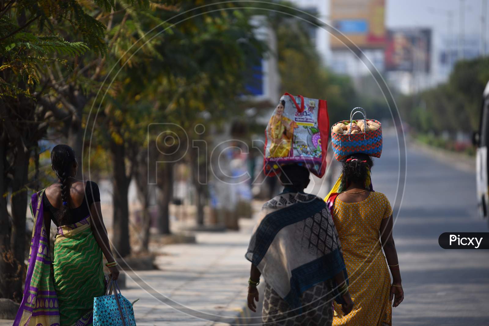Women buy vegetables at a makeshift market at Hitech city MMTS station and walk towards Madhapur amid corona virus pandemic in Hyderabad