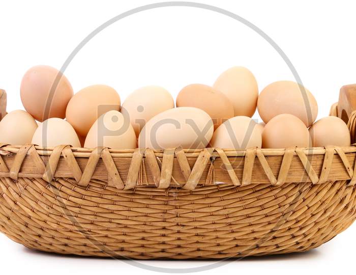 Wicker Basket Fool With Eggs. Isolated On A White Background.