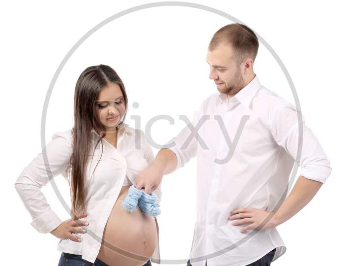 Beautiful Couple Expecting A Baby. Isolated On A White Background.