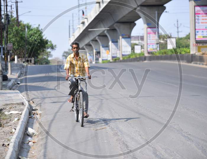 a man moves on a cycle on a deserted road at Jubilee Checkpost, amid nationwide lockdown due to corona virus pandemic outbreak