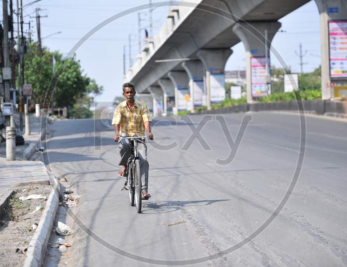 a man moves on a cycle on a deserted road at Jubilee Checkpost, amid nationwide lockdown due to corona virus pandemic outbreak