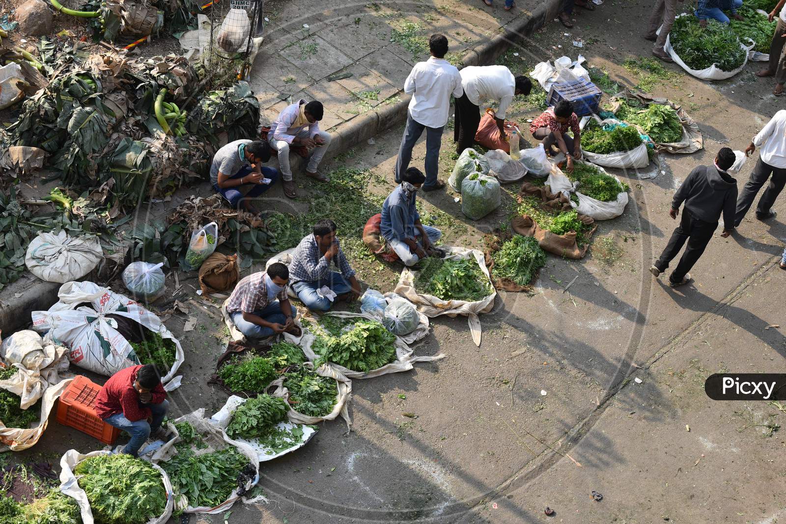 People fail to maintain social distance as they buy groceries, vegetables and fruits in a makeshif market under Kphb-Madhapur Flyover