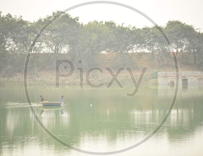 Fisherman Fishing In a Lake On Coracle Boat