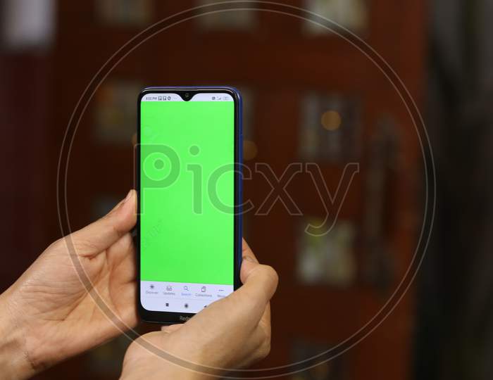 Indian Housewife Or Woman Hands Using Smart Phone With Green Screen