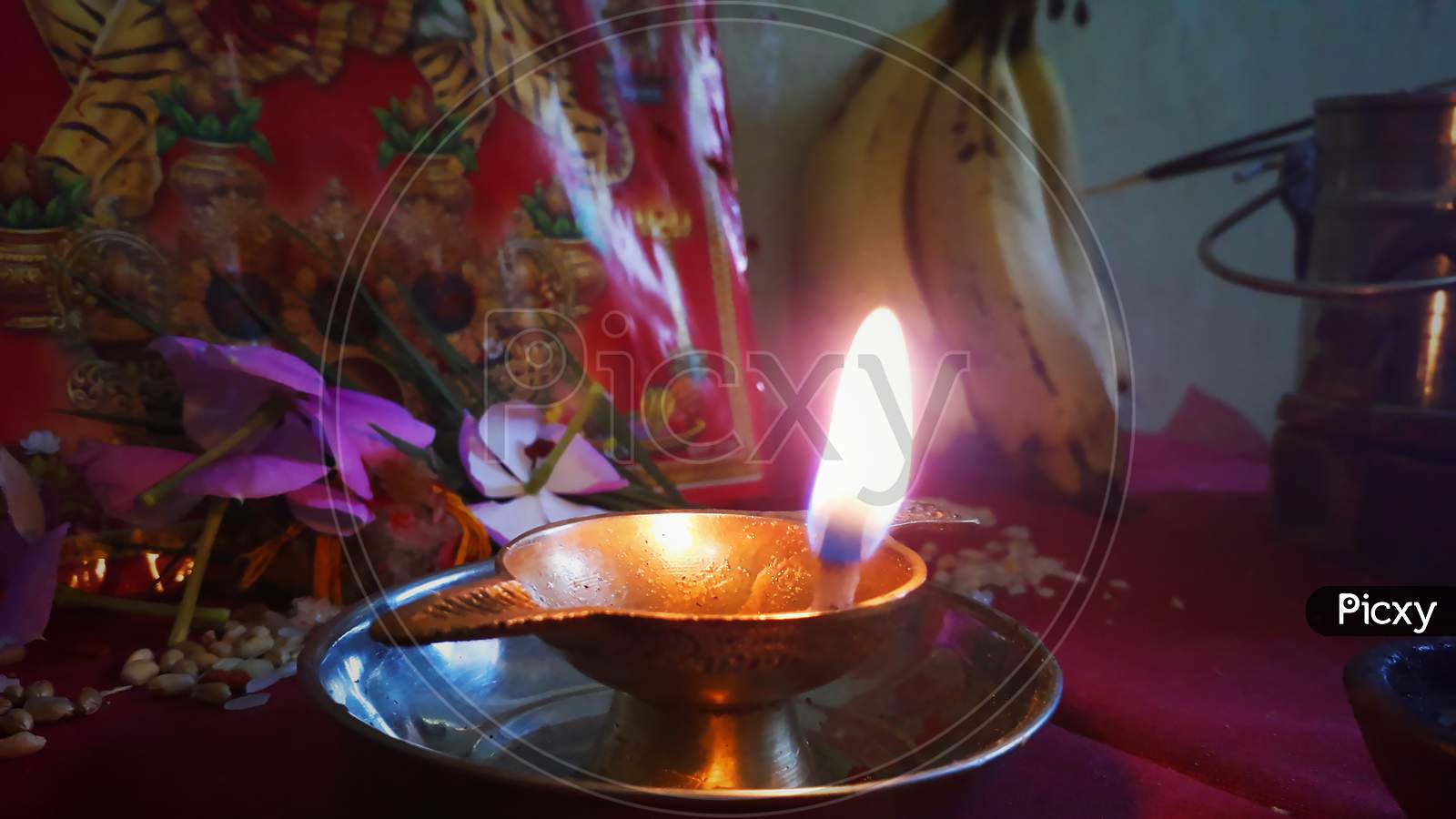 A golden lamp or 'Deepak' in front of Hindu Goddess 'Durga' / Devotion to Indian Goddess 'Durga'
