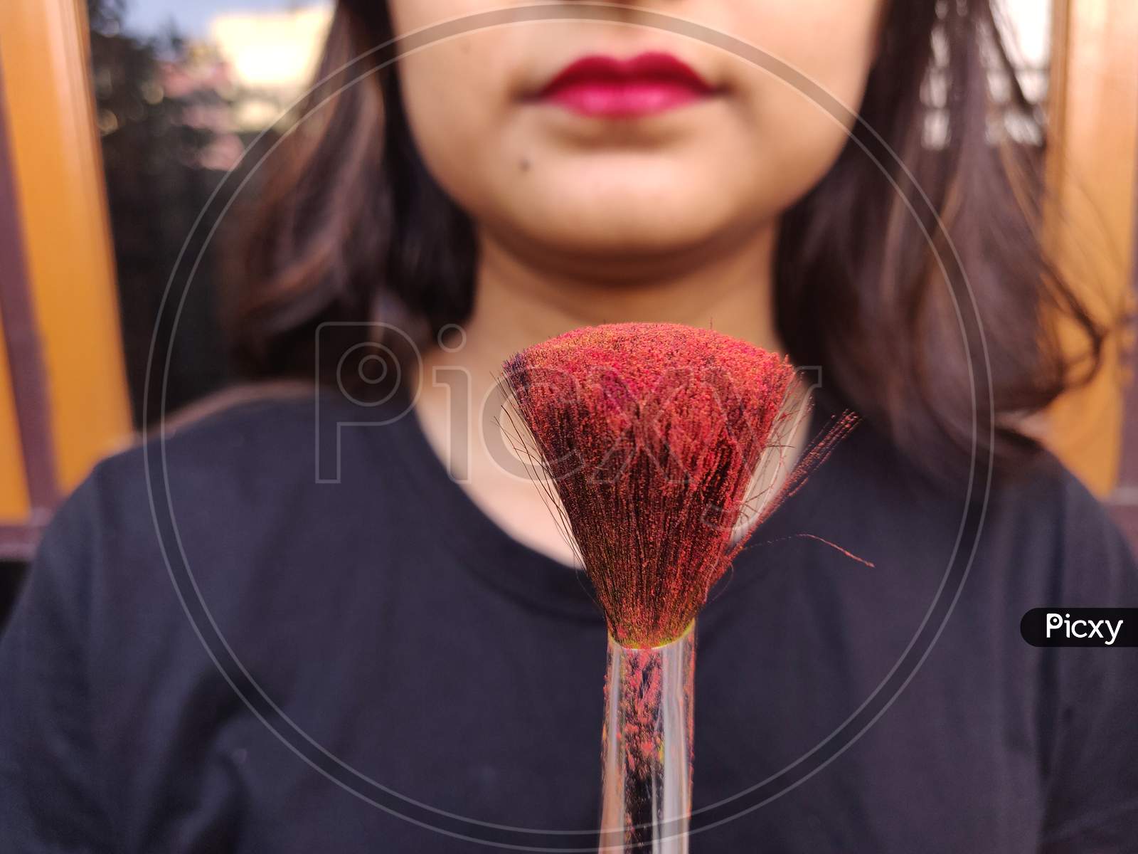 Makeup brush with red color on it