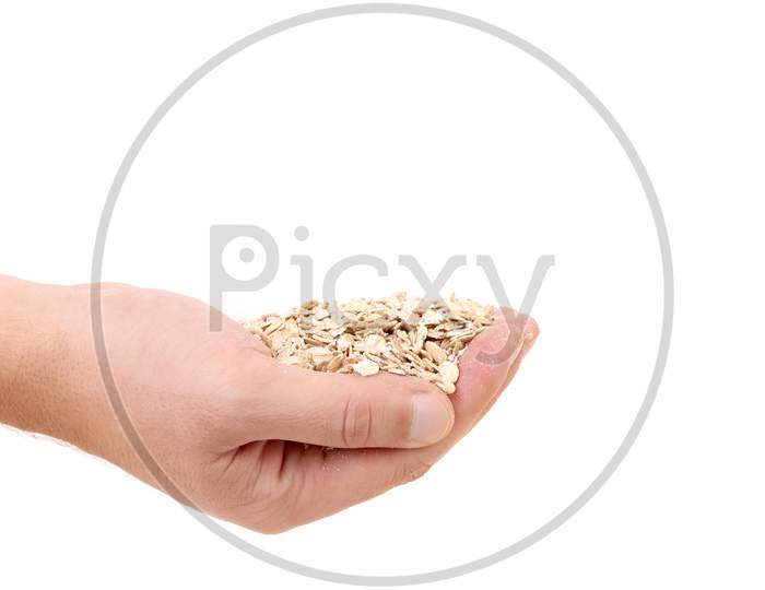 Oatmeal Flakes Into Hand.  Isolated On A White Background.