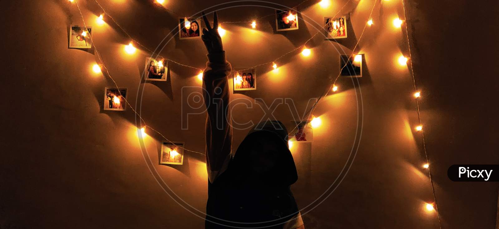 Girl in front of fairy lights