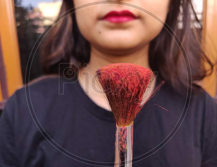 Makeup brush with red color on it