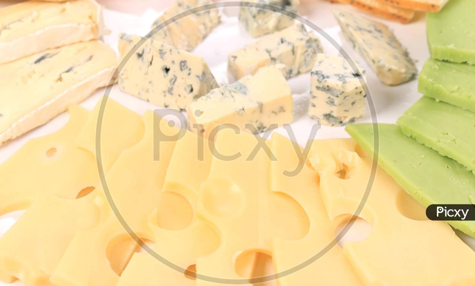 Various Cheese On Wooden Platter. Whole Background.