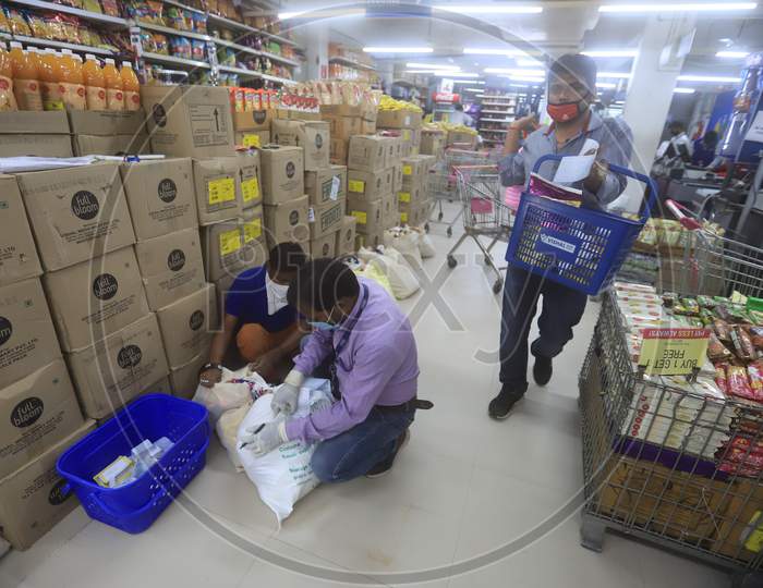 Supermarket or Mall workers packing food items for door to door service during a 21-day nationwide lockdown to limit the spreading of coronavirus disease (COVID-19),  March 30, 2020.