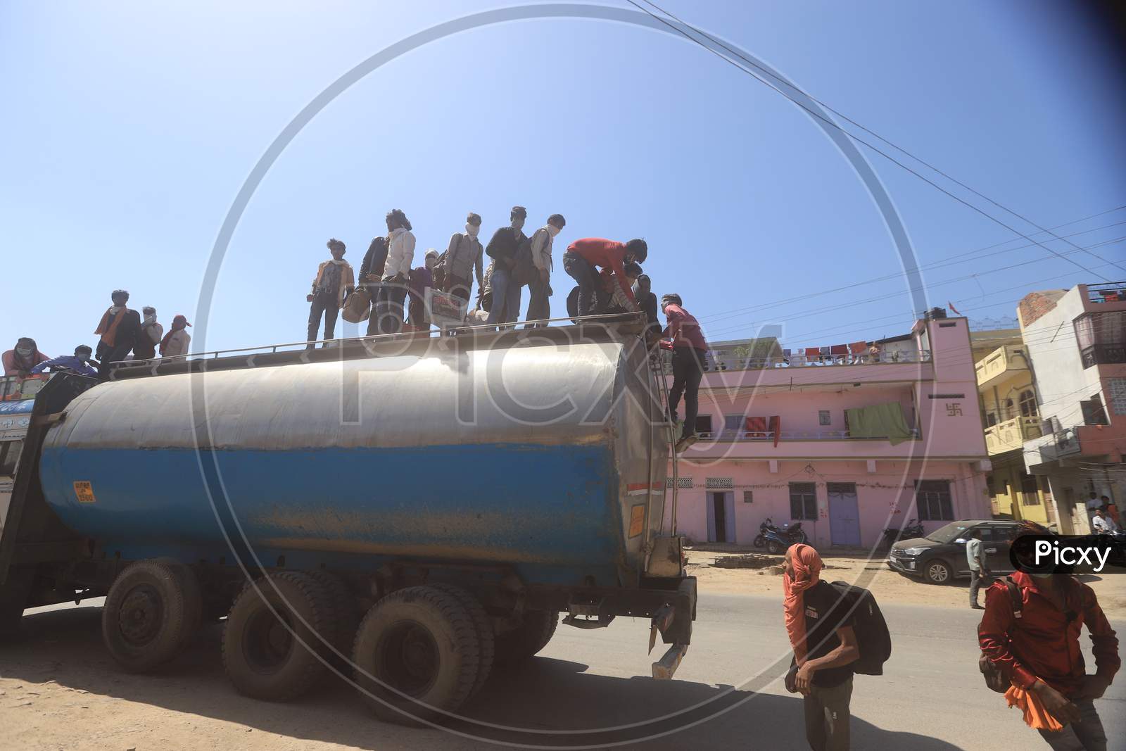 Migrant workers step down from a tanker arrived from Delhi during a 21-day nationwide lockdown to limit the spreading of coronavirus disease (COVID-19),  March 30, 2020.