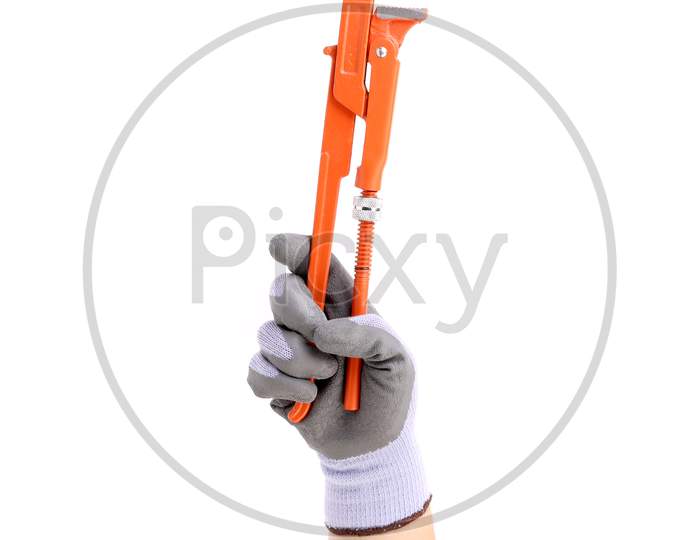 Hand In Gloves Holding Wrench. Isolated On A White Background.