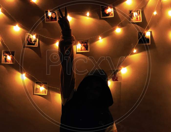 Girl in front of fairy lights