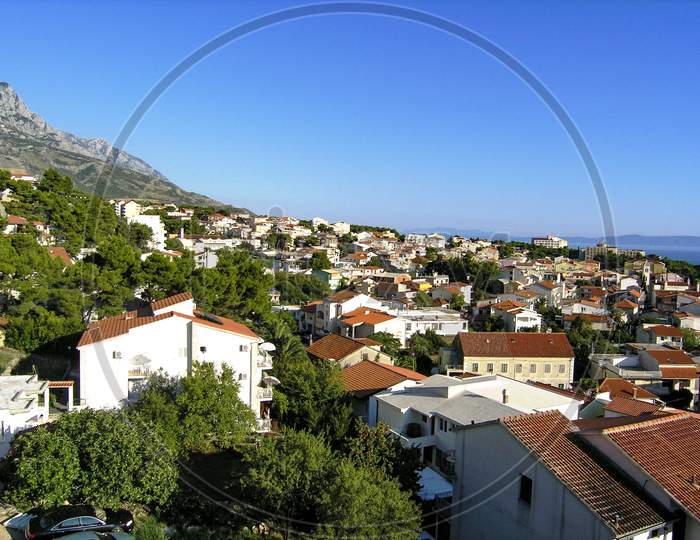 Panorama of Baška Voda with Adriatic sea and Biokovo mountains in the background.