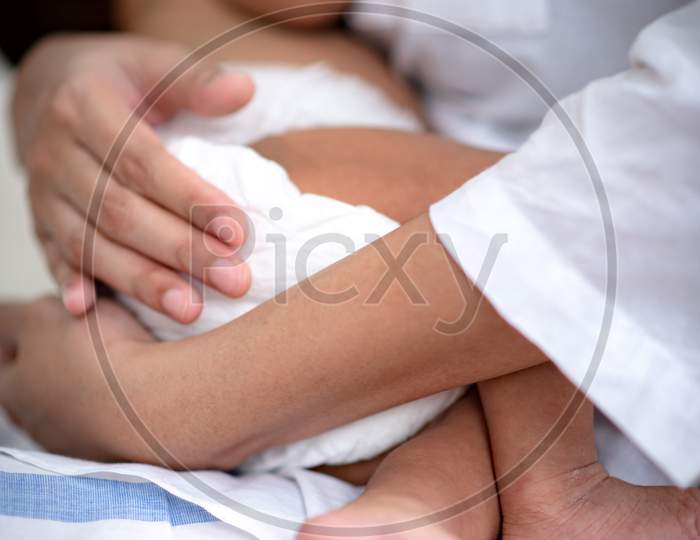 Asian Parent Hands Holding Newborn Baby Fingers, Close Up Mother'S Hand Holding Their New Born Baby. Love Family Healthcare And Medical