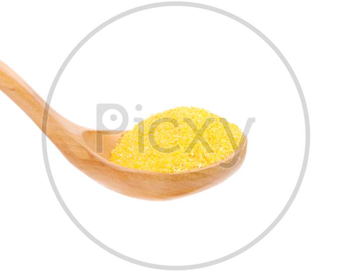 Corn Адщгк Into Wooden Spoon. Isolated On A White Background.