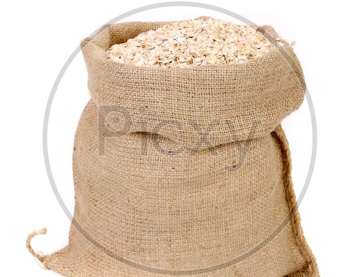 Oatmeal Flakes In Sack. Isolated On A White Background.