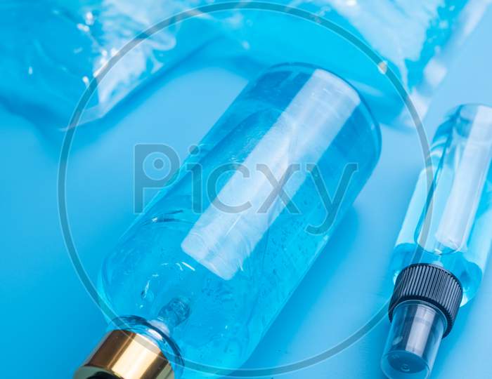 Alcohol Gel And Spay For Covid-19 Coronavirus Protection, Blue Background