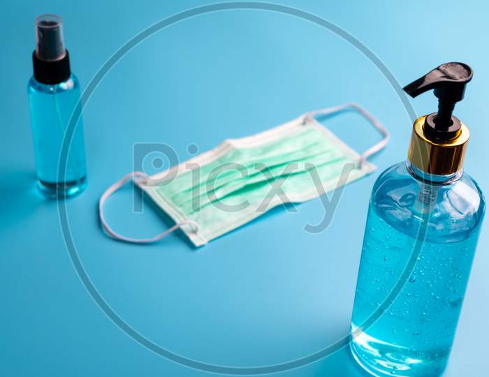 Alcohol Gel And Spay For Covid-19 Coronavirus Protection, Blue Background