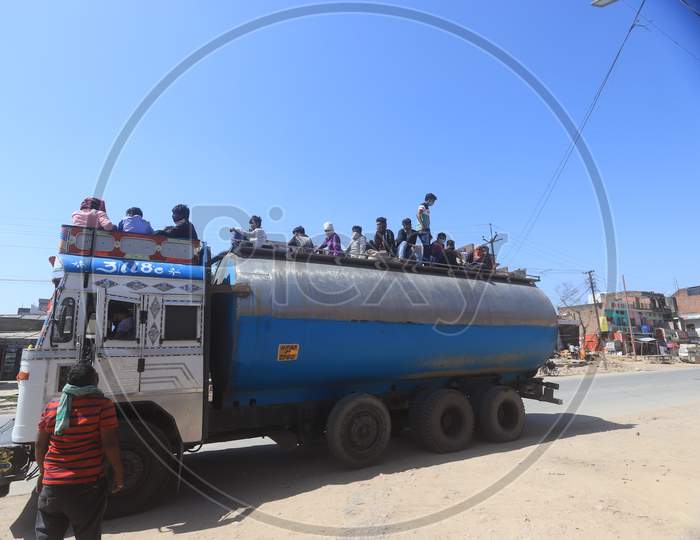 Migrant workers step down from a tanker arrived from Delhi during a 21-day nationwide lockdown to limit the spreading of coronavirus disease (COVID-19),  March 30, 2020.