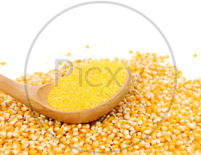 Corn Grain Into Wooden Spoon. Isolated On A White Background.