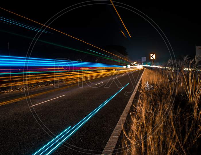 Light trail of vehicles passing in the national highway.