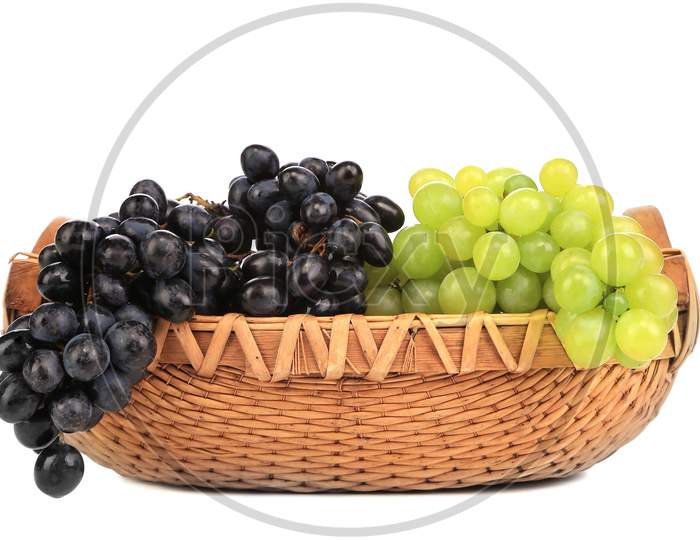 Greenand Black Grapes In Basket. Isolated On A White Backgropund.