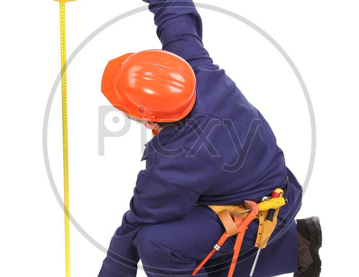 Worker In Hard Hat Measure With Ruler. Isolated On A White Background.