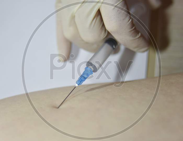 The Procedure Of Intramuscular Injection By The Hand In Medical Glove. Medical Treatment Concept.
