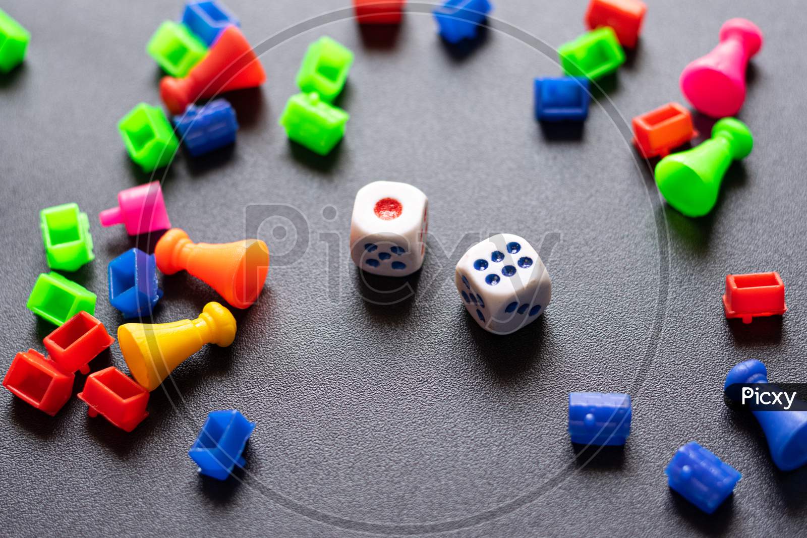 Colorful Plastic game pieces and dice used to play in business game