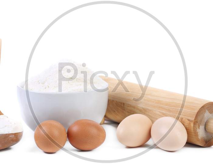 Composition Of Flour And Eggs. Isolated On A White Background.