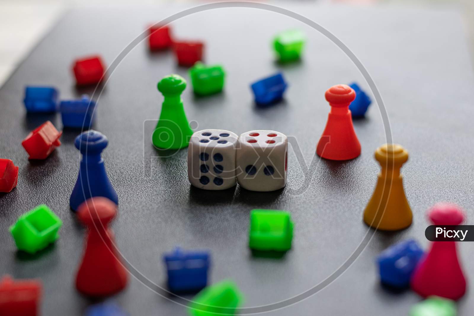 Colorful Plastic game pieces and dice used to play in monopoly game