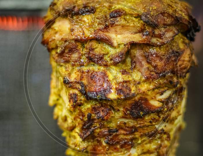 Fresh Shawarma With Tray Full Of Shawarmas. Shawarma Is One Of The Most Popular Fast Food Dish In Asian And Middle Eastern Countries.Closeup Picture Of Stacked Meat Roasting Chicken Shawarma
