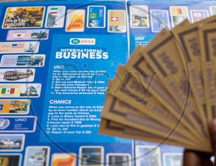 Cards and board for business game played indoor