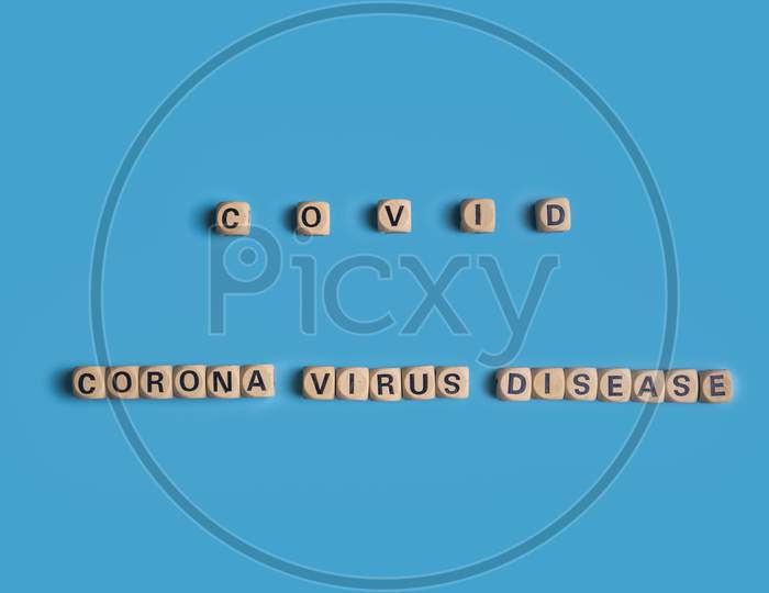 The Word Text Of Covid And Corona Virus Disease 2019 On Blue Background