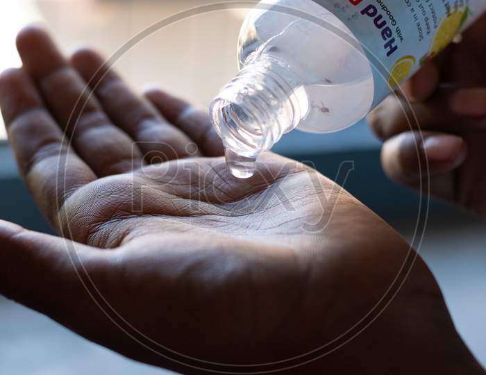 Hand sanitizer being applied on hands to avoid the spread of corona virus covid 19