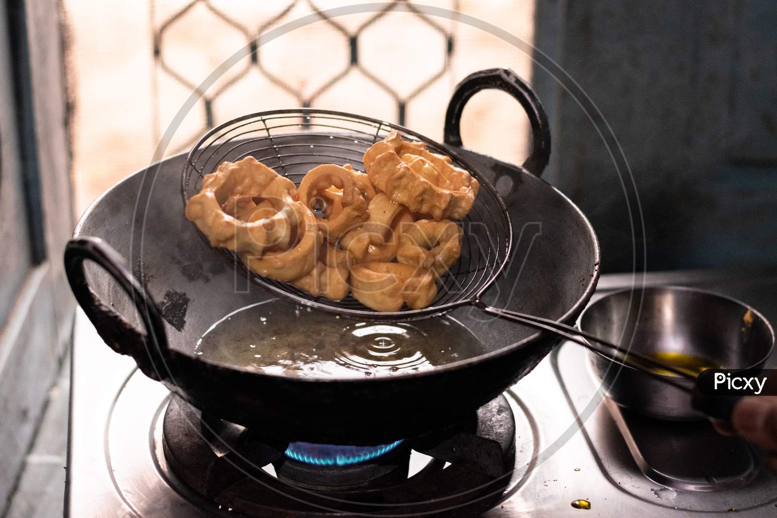 Indian Traditional Sweet Named Malpua Cooking in Hot Oil in Kadai (Frying  Pan). This Delicious Dessert is Famous in Ajmer - Rajasthan, India. Stock  Photo