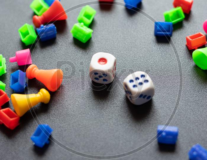 Colorful Plastic game pieces and dice used to play in business game