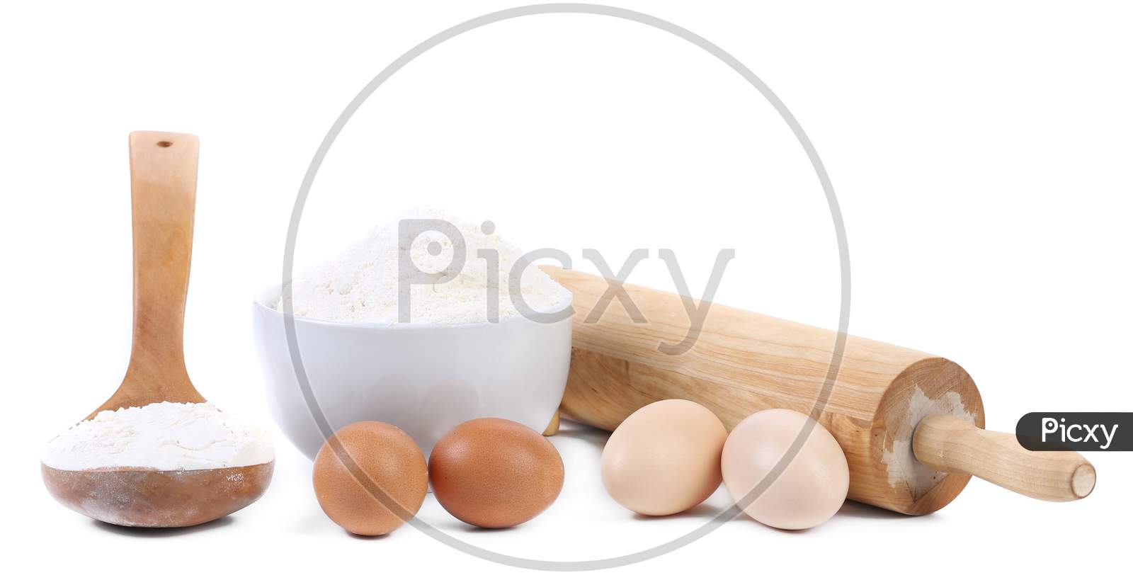 Composition Of Flour And Eggs. Isolated On A White Background.