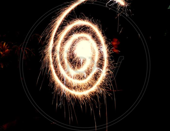 A person celebrating diwali with fireworks, Long exposure photography. Have space for text.