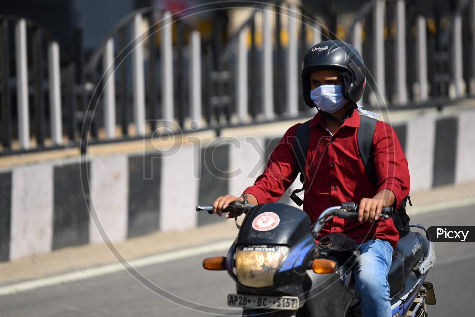 A man drives his two wheeler wearing a Face Mask amid Novel Corona Virus Outbreak in Hyderabad, COVID-19