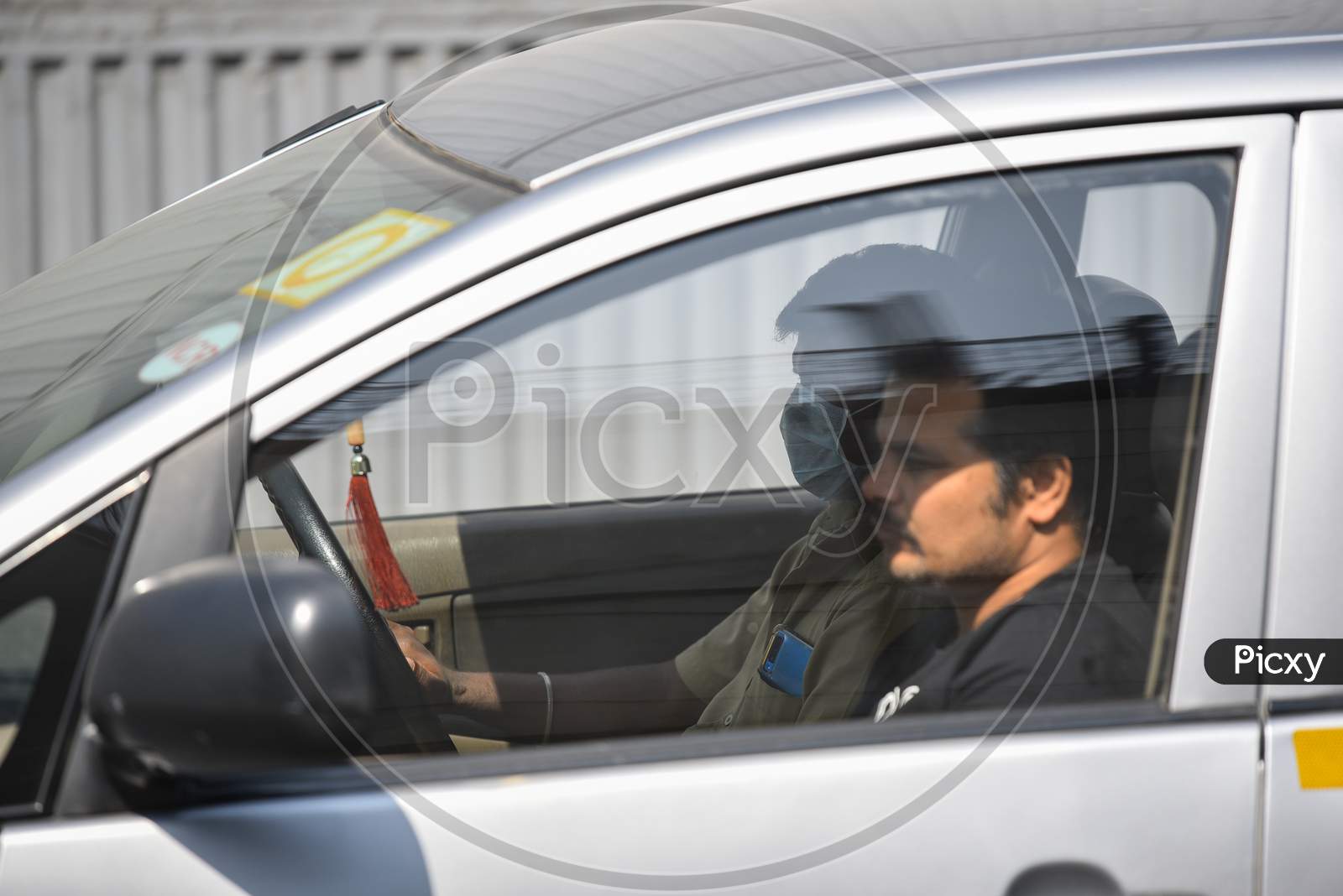 A man drives his car wearing a Face Mask amid Novel Corona Virus Outbreak in Hyderabad, COVID-19