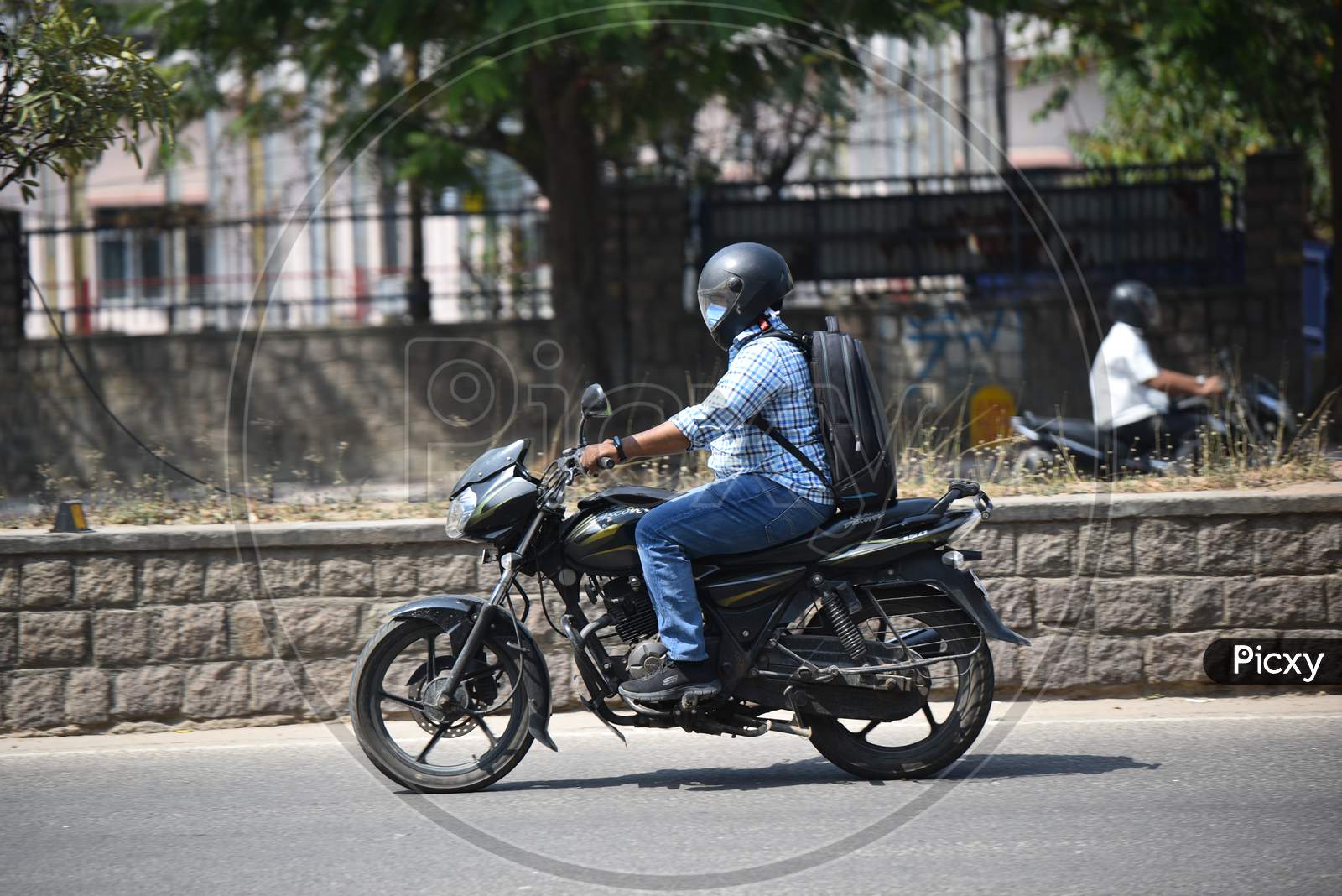 a two wheeler rider wearing a Face Masks amid Novel Corona Virus Outbreak in Hyderabad, COVID-19