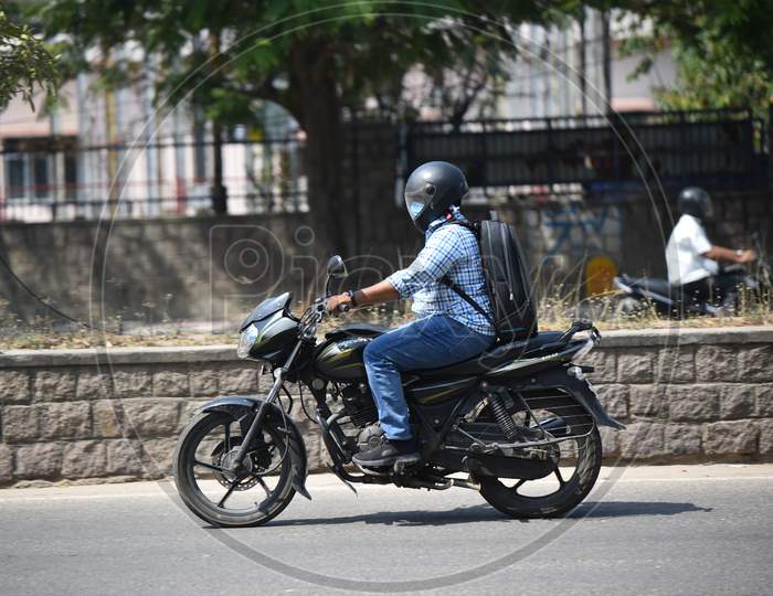 a two wheeler rider wearing a Face Masks amid Novel Corona Virus Outbreak in Hyderabad, COVID-19