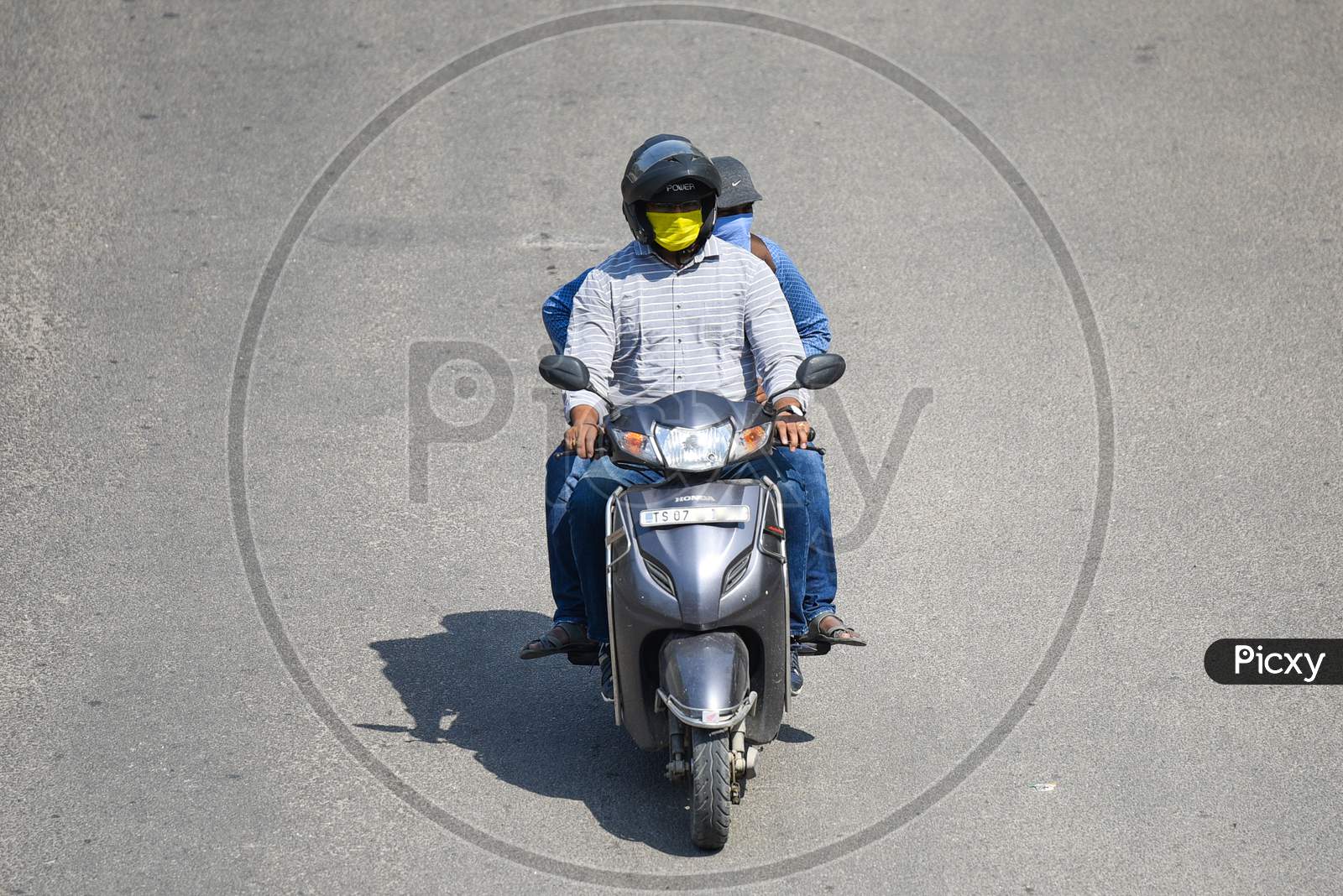A man drives his two wheeler wearing a Face Mask amid Novel Corona Virus Outbreak in Hyderabad, COVID-19