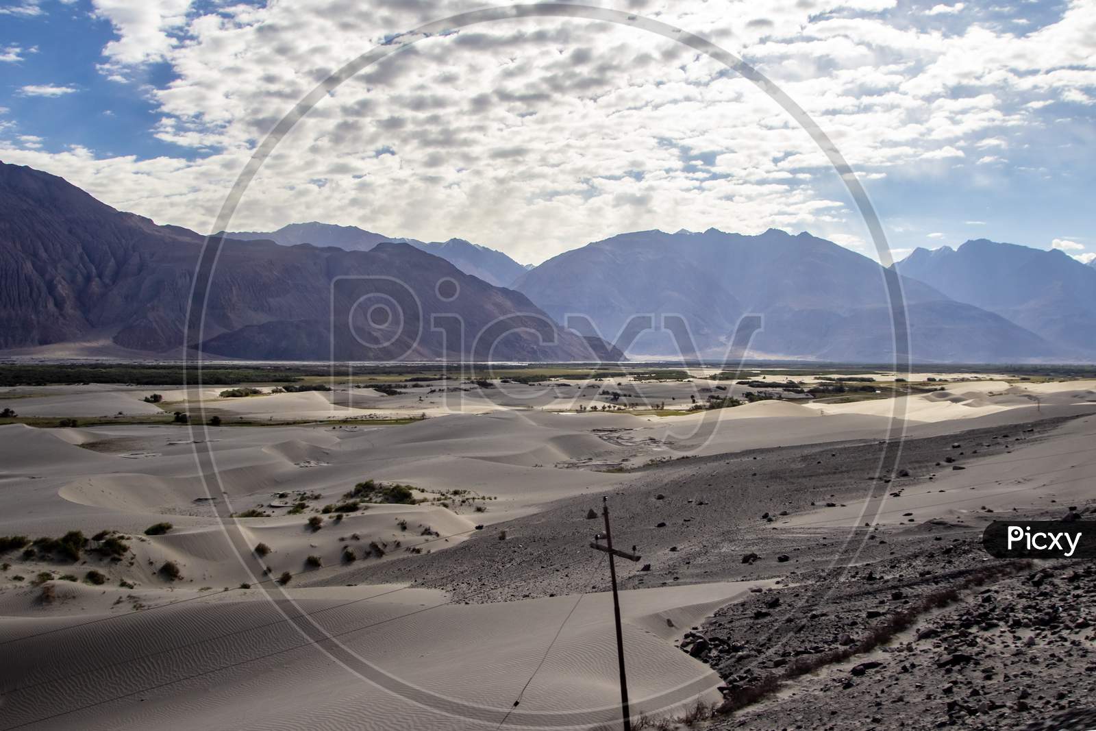 Arid Dry Dessert Sand Dunes Of Nubra Valley With Himalayan Barren Mountain Range In The Background At Ladakh, Kashmir, India