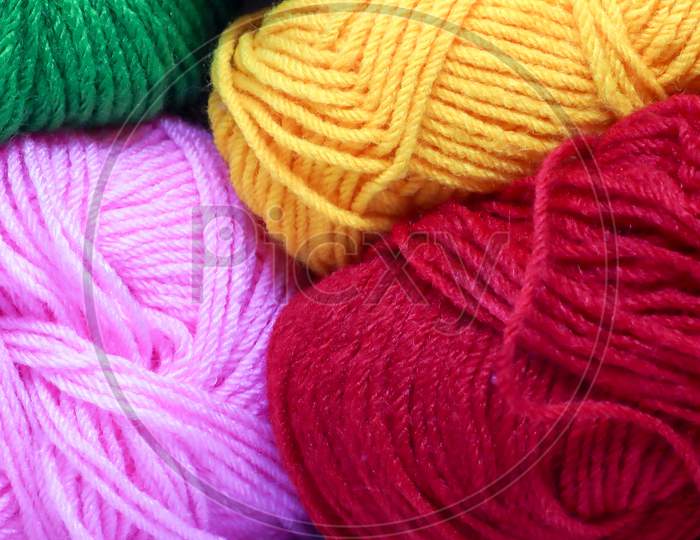 Balls Of Pink Green Red Yellow And White Colored Wool