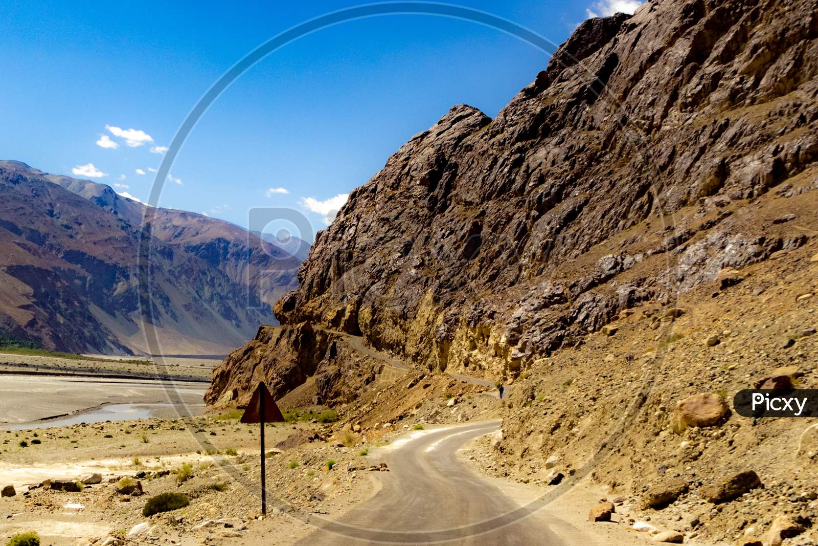 Curved Hilly Highway In Between Barren Himalayan Mountains Of Leh Ladakh, Jammu And Kashmir, India