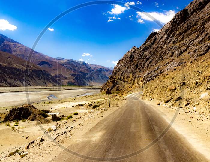 Curved Hilly Highway In Between Barren Himalayan Mountains Of Leh Ladakh, Jammu And Kashmir, India